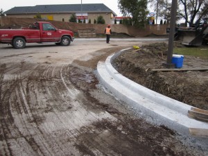 Freshly formed concrete curb along a new roadway