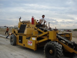 A VP-branded motor grader levelling granular base on a Vaughan Paving site